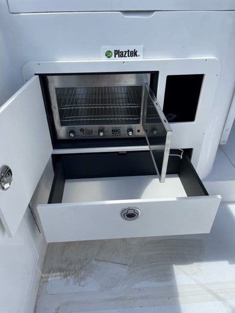 Installed product on a Blackwatch 36. Shown with the pie warmer installed and bottom drawer fully open. Made by Plaztek using King StarBoard.